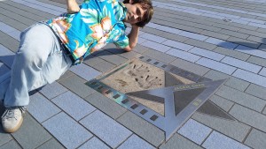 Posing with Jackie Chan's hand prints on the Hong Kong Avenue of Stars