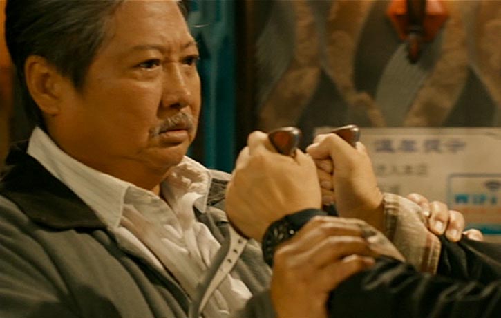 Ding Hu restrains his knife wielding adversary.jpg