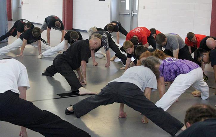 Bill shows his students how to ease into a split