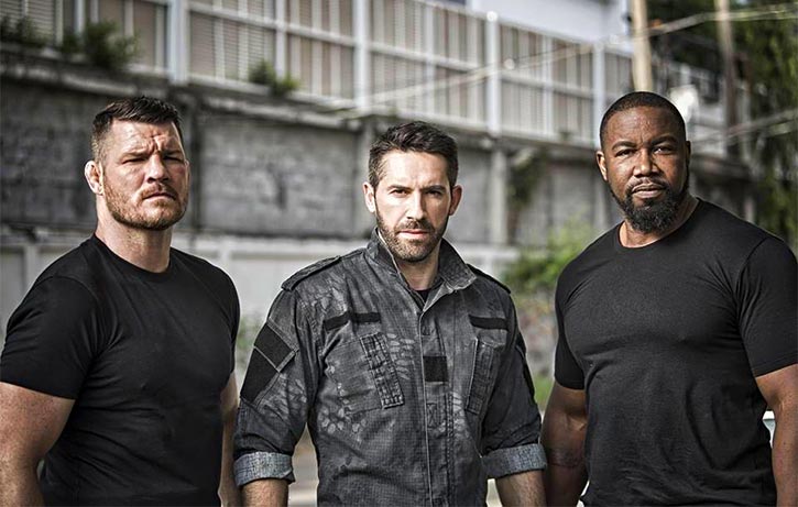 Mike forms a villainous Triple Threat with Scott Adkins and Michael Bisping