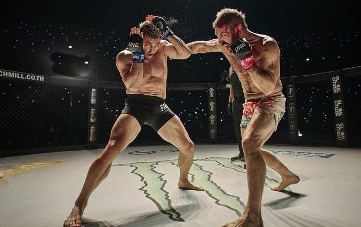 Xavier deflects Patton's punch.